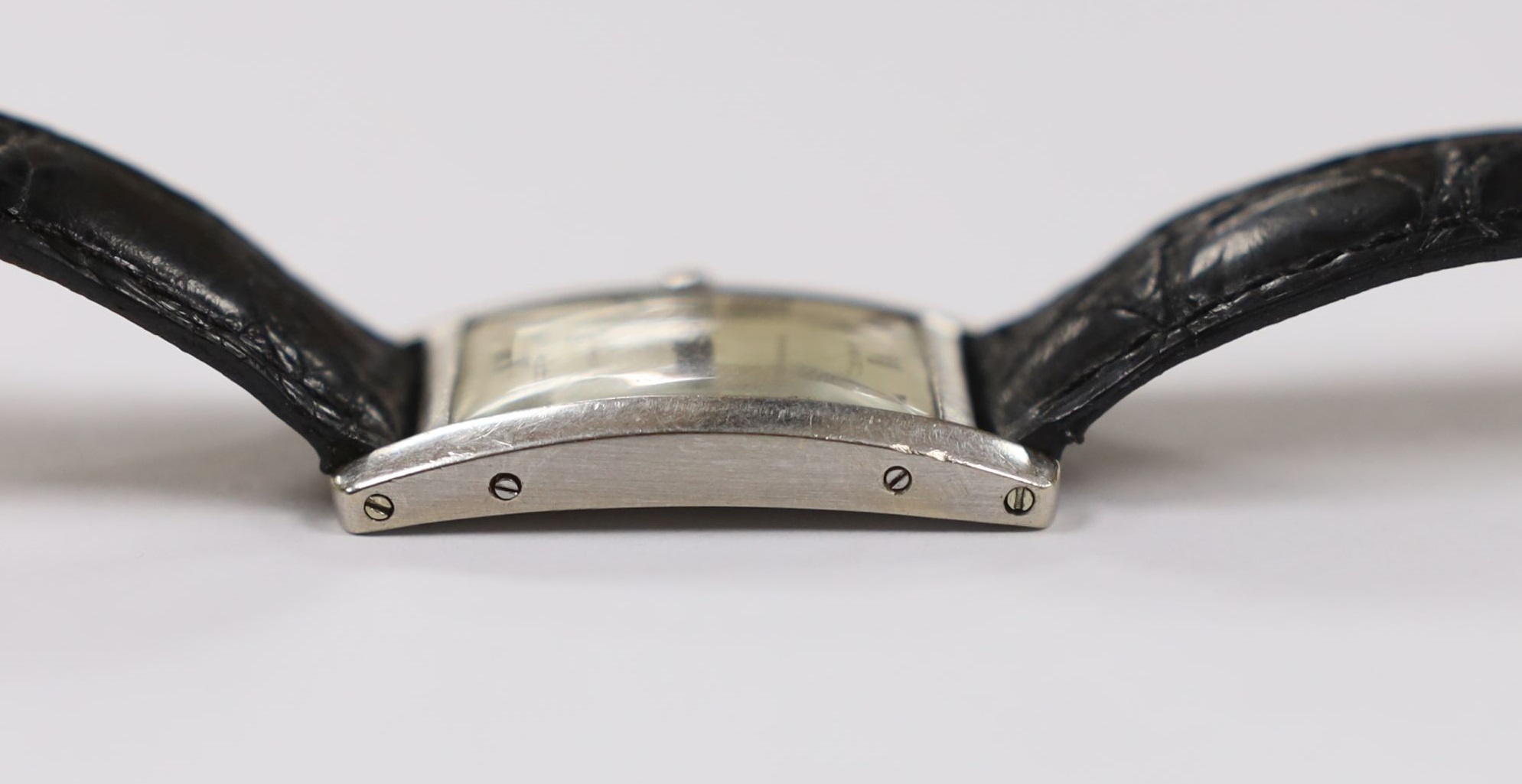 A 1920's 18ct white gold Cartier Tank Cintree (7 lignes model) manual wind wrist watch, with later 1970's movement